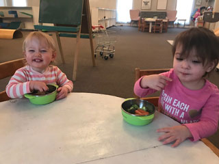 Image of two children eating a snack