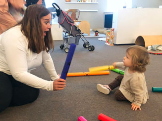 Image of a woman and child playing with music toys.